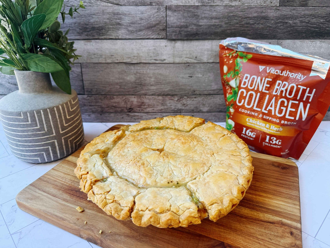 Simple chicken pot pie on a wodden platter board, with Vitauthority's Bone Broth Collagen in Chicken & Herb flavor featured in the background. 