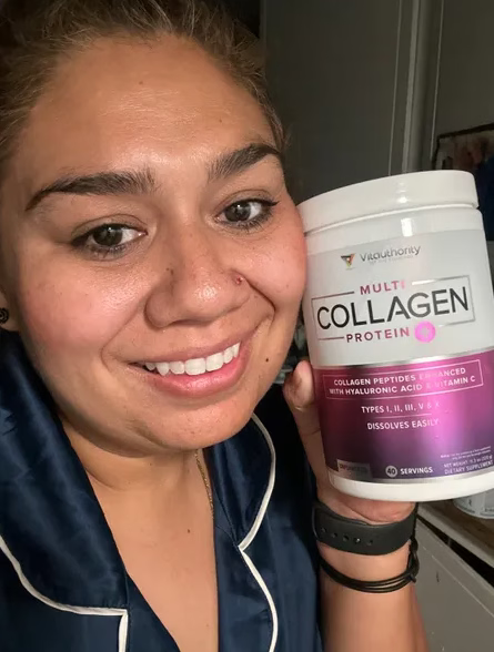 Woman takin a selfie while holding a container of Multi Collagen Protein 